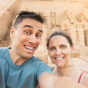 Tourist taking a selfie in front of an egyptian temple